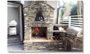 Outdoor fireplace with pizza oven, connected to an outdoor kitchen near San Jose