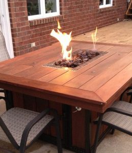 Outdoor fire table with lava rock in a Bay Area backyard