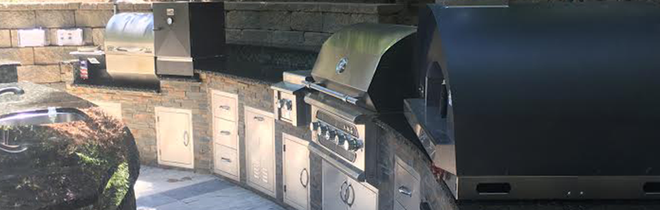 Outdoor kitchen in the San Jose area with grill, smoker, side burner and pizza oven