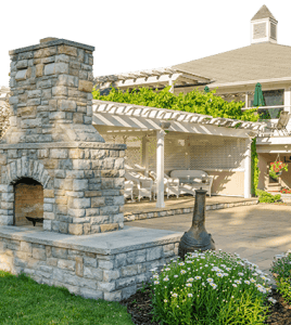 beautiful outdoor stone fireplace and covered patio